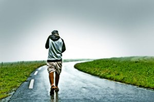 man-walking-away-on-lonely-road